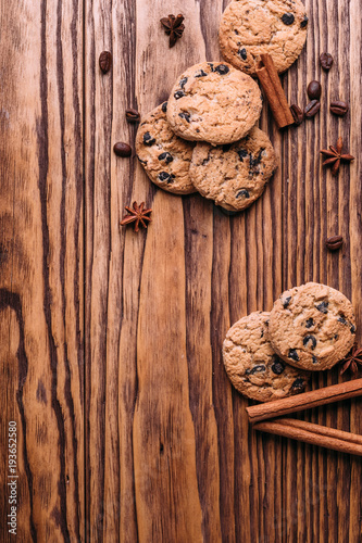 oatmeal cookies with chocolate on a wooden background