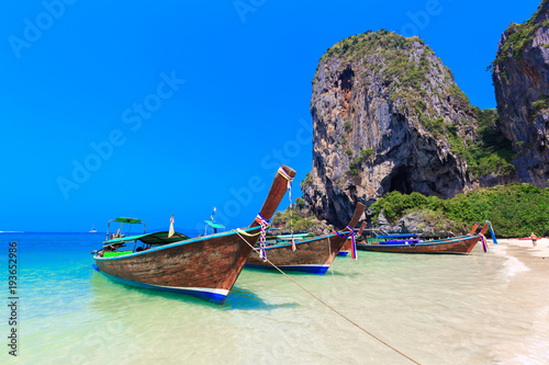 Railey beach, Long Tail Boats are getting ready to bring tourists to different island for swimming and snorkeling, Ao Nang, Krabi, Thailand. photo