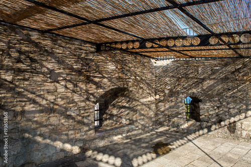 premises of the fortress under the thatched roof during the sun with shade in Herceg Novi Montenegro photo