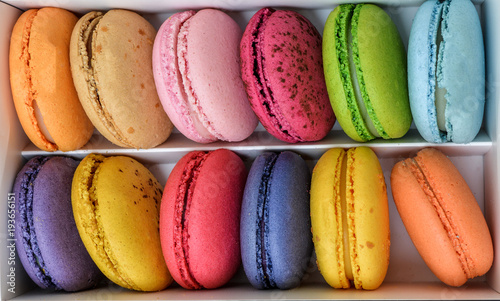 Macaroons in a box top view. Assortment of multicolored macaroon different lie in the cardboard box with the top view
