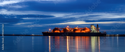 LNG TANKER AT THE GAS TERMINAL - Sunrise over the ship and port
