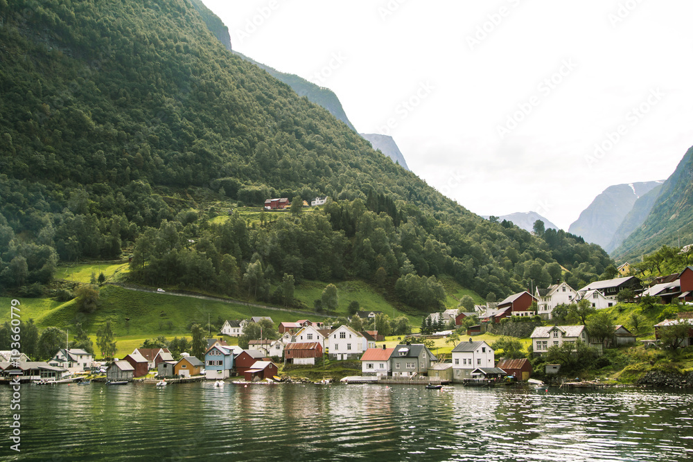 Landscape of small village in the mountains next to sea. Sognefjord, Norway