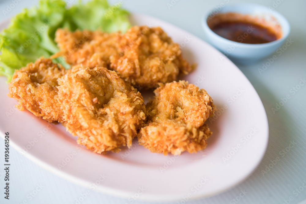 Thai fried shrimp cake on pink plate with sweet chili sauce. Thai fried shrimp cake on pink plate with sweet chili sauce.