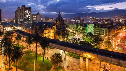 Medellin, Colombia, time lapse view of downtown buildings and Plaza Botero square at dusk. Zoom out. photo