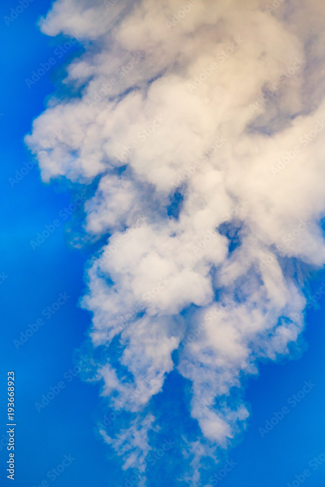 smoke from a pipe in the factory against a blue sky smoke from a pipe in the factory against a blue sky