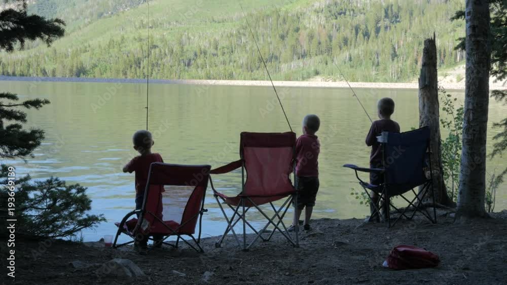 Three little brothers fishing in a lake. Three little brothers fishing in a lake.