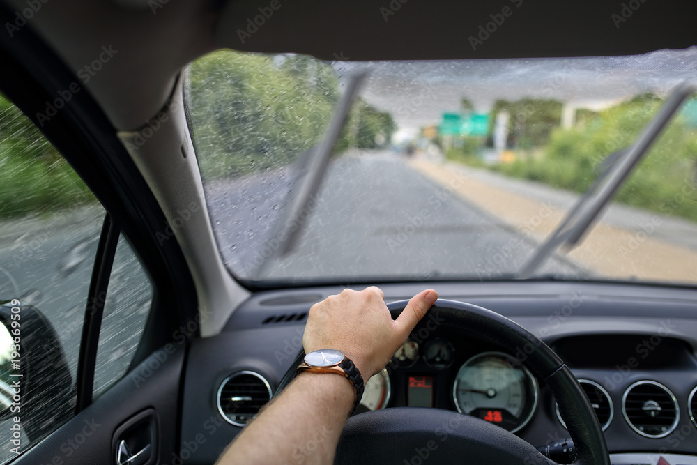 Driving a car on a gray and cloudy rainy day
