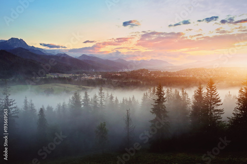 misty sunset over the mountains © ambrozinio