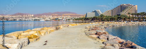 Morning view on Eilat - a famous Israeli city with beautiful sandy beaches, hot sun and clear blue skies, surrounded by stunning mountains and desert scenery 