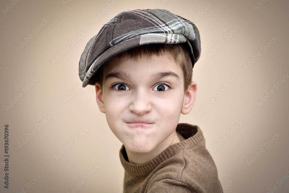 Portrait of an angry young boy with cap. Vintage style. Portrait of an angry young boy with cap. Vintage style.