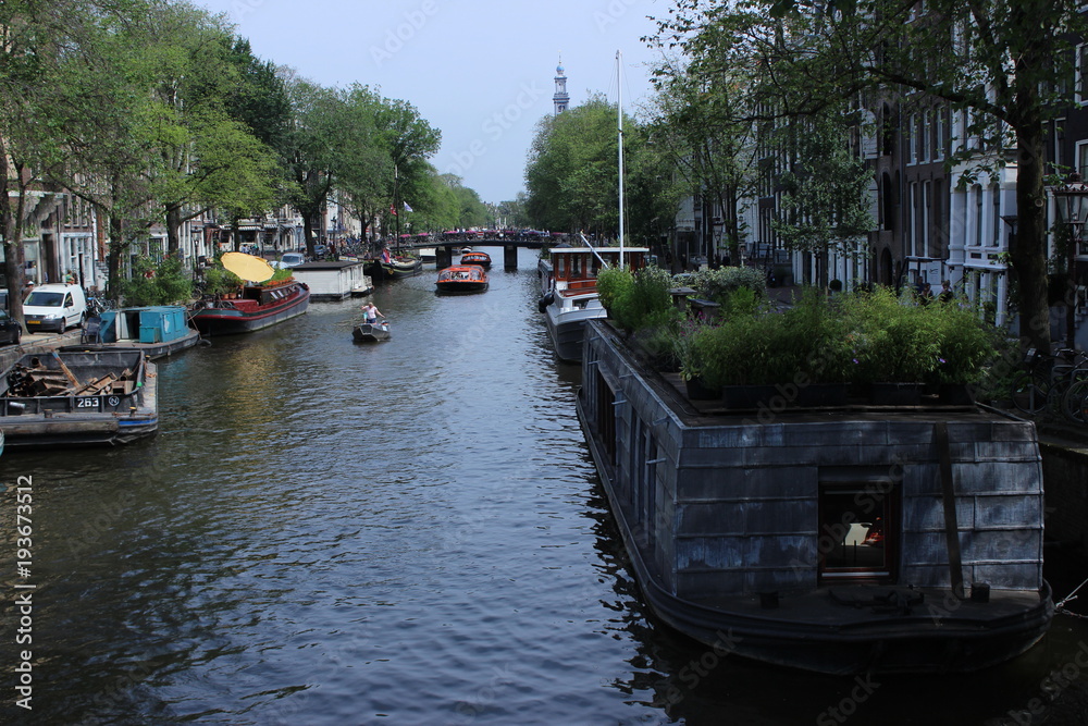 Amsterdam cannal with boats and houses