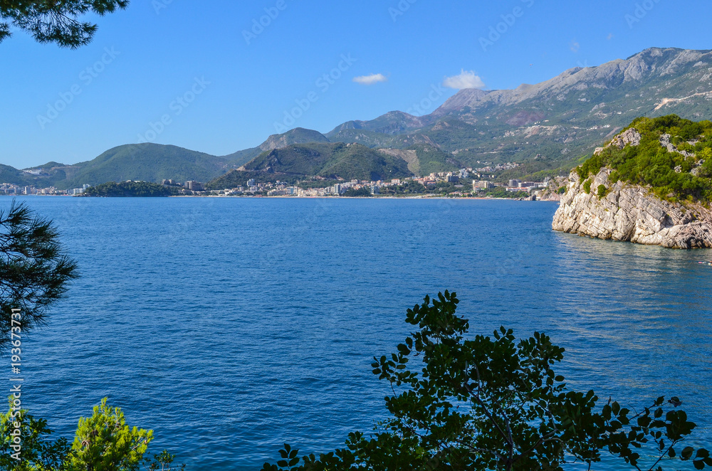 Fototapeta premium Beautiful sea view. The mountains descend into the sea. Blue sky and turquoise water. Adriatic Sea. Montenegro.