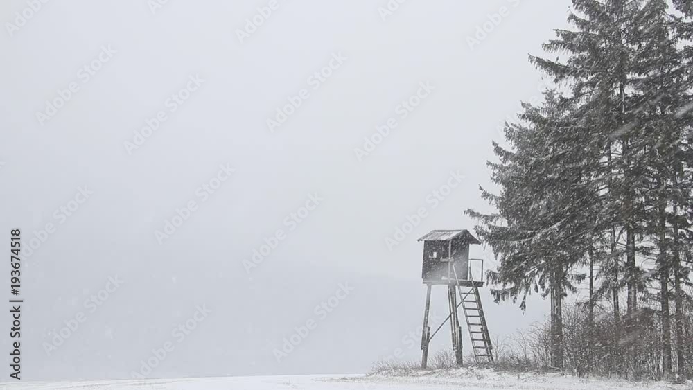 Hunting tower in countryside during heavy snowing Hunting tower in countryside during heavy snowing