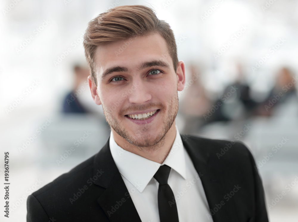 portrait of confident young businessman on blurred background. portrait of confident young businessman on blurred background.
