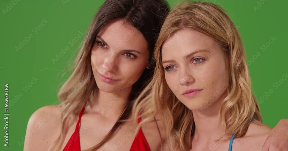 Tight shot of beautiful young women with looking sad in front green screen wall Tight shot of beautiful young women with looking sad in front green screen wall