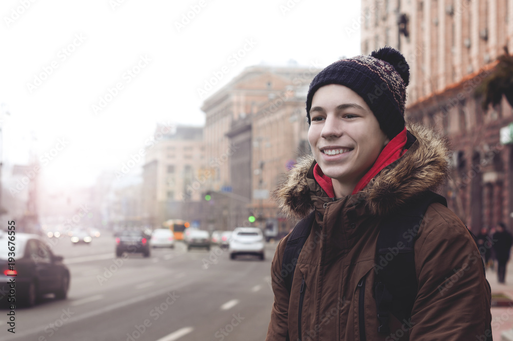 happy young man on the street of the city