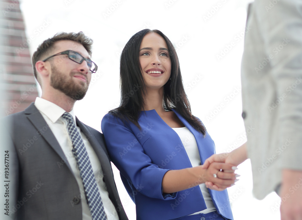 Businesswomen Shaking Hands In Modern Office