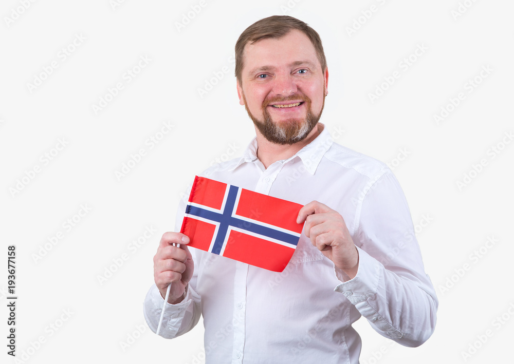 Adult man with a beard in a white shirt holds the flag of Norway. Adult man with a beard in a white shirt holds the flag of Norway.
