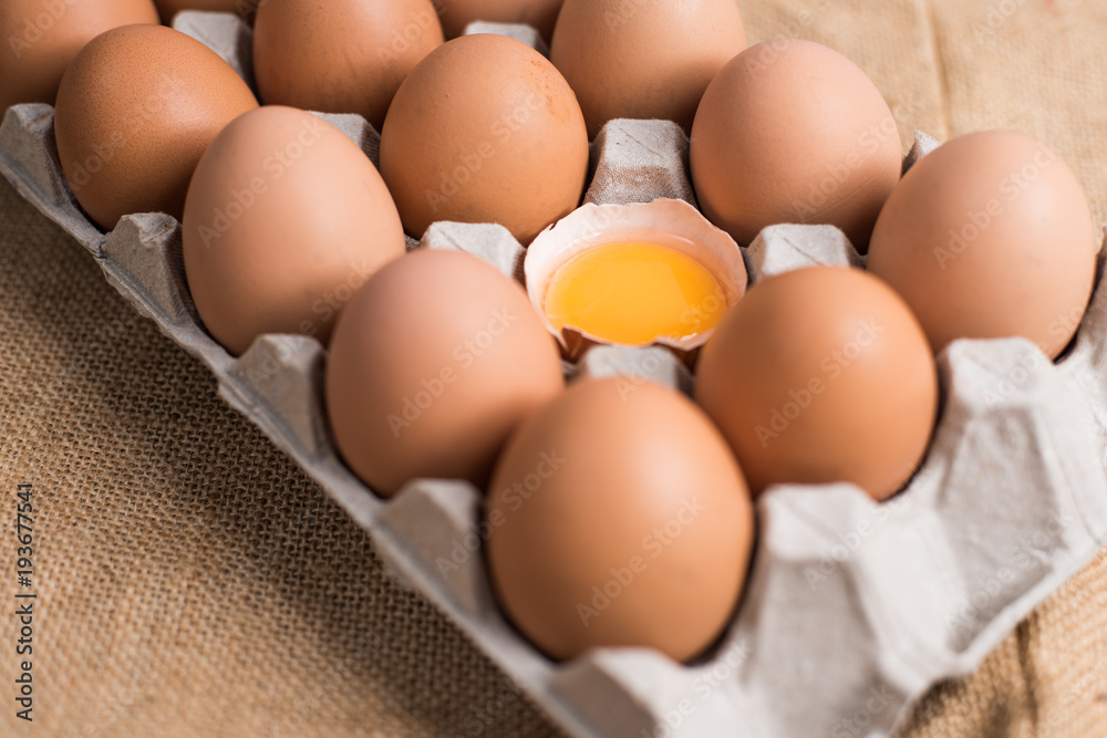 Eggs in the egg panel on cloth background. Eggs in the egg panel on cloth background.