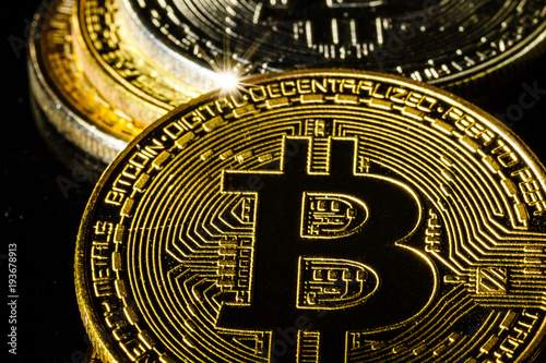 Golden bitcoin on black background with copy space cryptocurrency mining concept