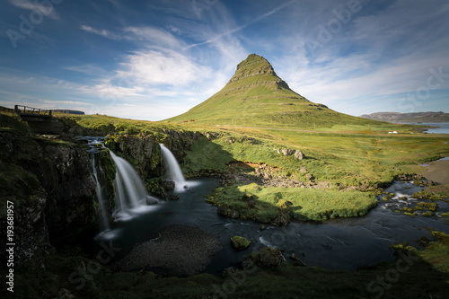 Kirkjufell and waterfall, green landscape. Snaefellsnes peninsula, Iceland