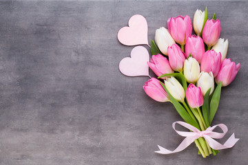 Mother's Day, woman's day, easter, pink tulips, presents on gray  background.