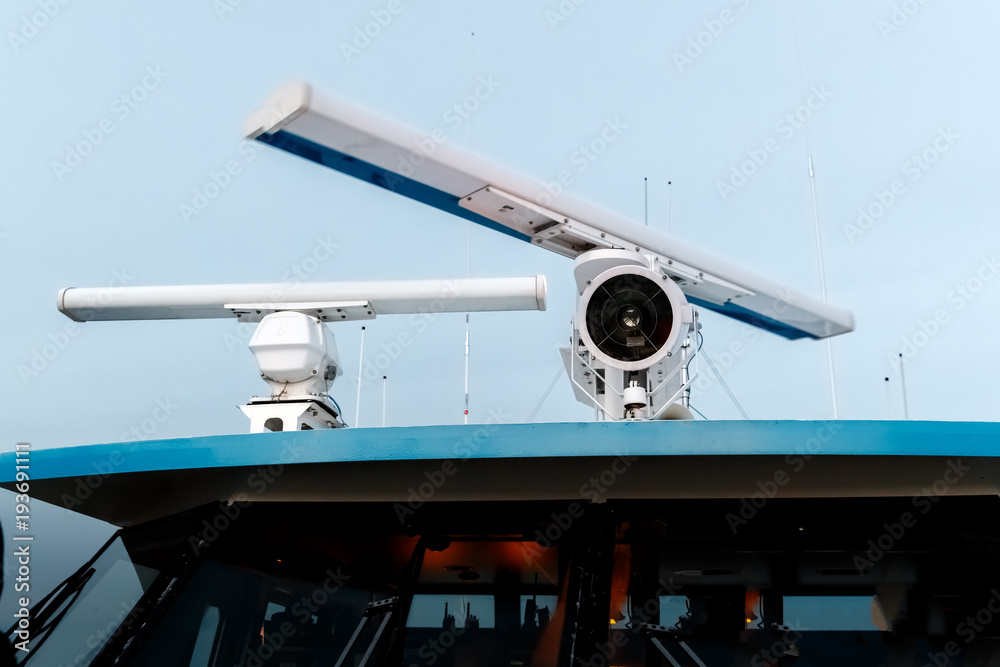 Rotating antenna of marine radar and a lantern on top of the ship