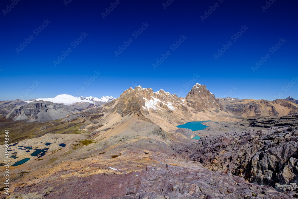 On the Huayhuash alpine circuit at Trapezio Pass. This place is quite colorful and shows some incredible contrasts : snow and rock, blue lagoon and grey rock... On the Huayhuash alpine circuit at Trapezio Pass. This place is quite colorful and shows some incredible contrasts : snow and rock, blue lagoon and grey rock...