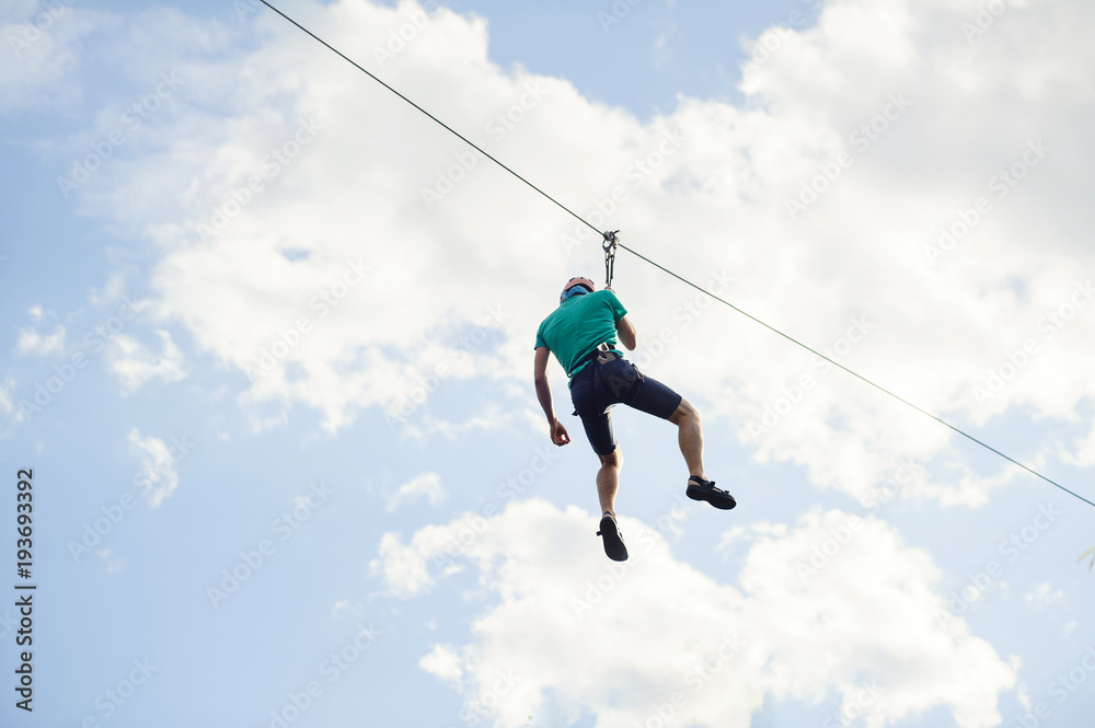 a man descends on a rope, a sport in an extreme park