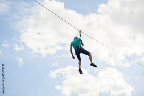 a man descends on a rope, a sport in an extreme park
