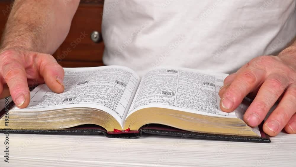 Man reading from the holy bible, close up Man reading from the holy bible, close up