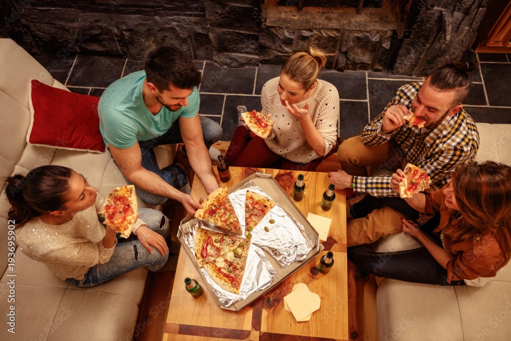 Top view of friends eating pizza and having party