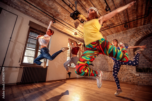 Fototapeta Naklejka Na Ścianę i Meble -  Group of modern dancer jumping during music