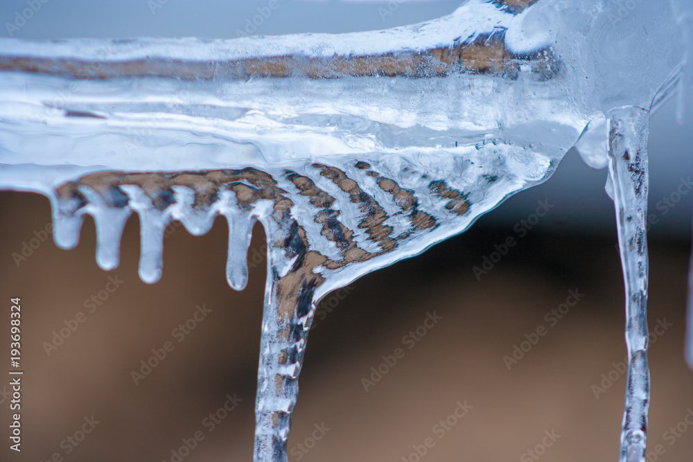 Close up of shiny and blue icicles with a dark background Close up of shiny and blue icicles with a dark background