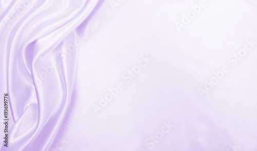 Smooth elegant lilac silk or satin texture as wedding background. Luxurious background design