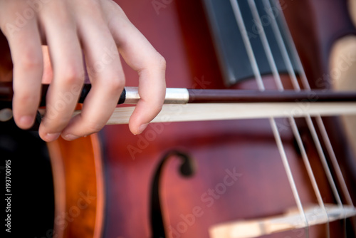 Detail of girl with her cello on the outside