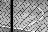 cage metal net at football court - monochrome