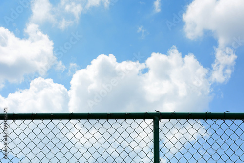 cage metal net front the blue sky