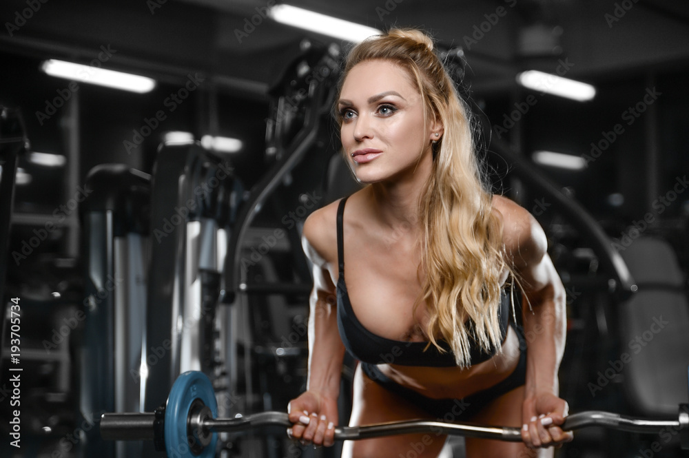strong sexy athletic young woman working out in gym strong sexy athletic young woman working out in gym