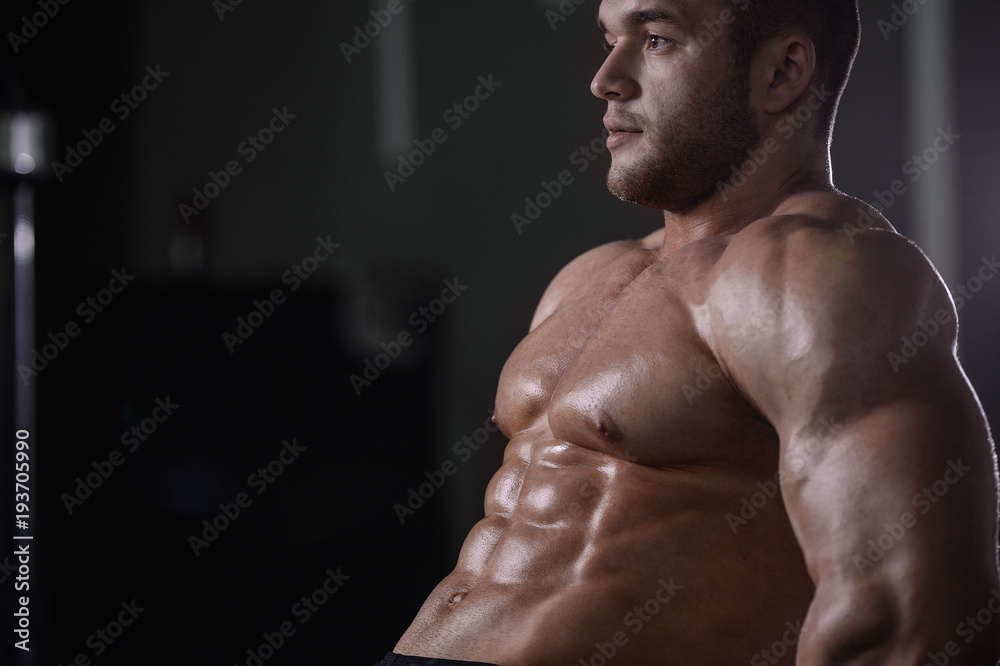 Fototapeta premium Brutal strong bodybuilder athletic men pumping up muscles with dumbbells