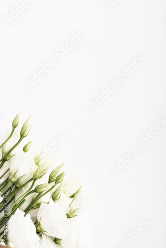 Bouquet of white roses on white wooden table