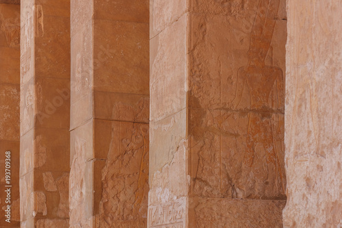 The stone columns with relief carving in Ancient Egyptian temple complex.