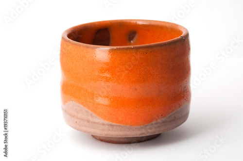 Orange pottery cup