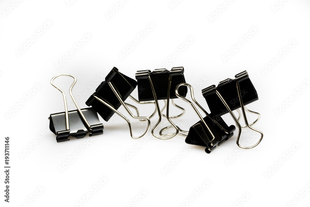 Colorful office paper clips isolated on white ground. Office accessories on a white table. Colorful office paper clips isolated on white ground. Office accessories on a white table.