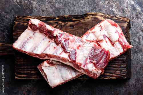 raw meat ribs on wooden cutting board photo