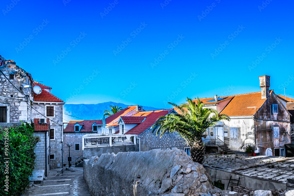 Fototapeta premium Supetar town mediterranean scenery. / Scenic view at picturesque town streets in mediterranean place Supetar on Brac island, Croatia.