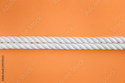White ropes on orange
