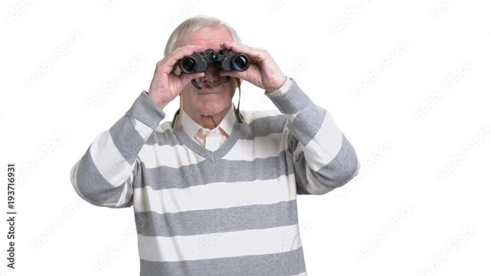 Elderly man using binoculars. Senior man looking through binoculars isolated on white background. Elderly man using binoculars. Senior man looking through binoculars isolated on white background.