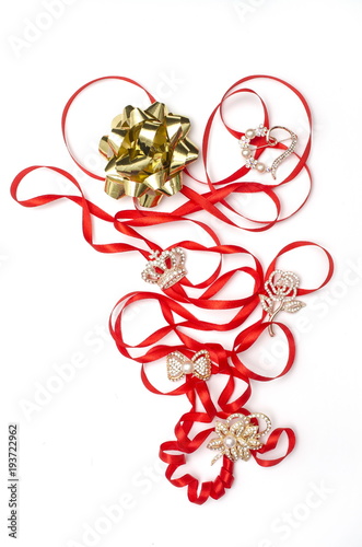 still life with brooches with ribbon and bow isolated on white