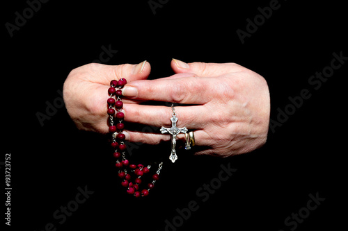 Female Hands Holding rosary Beads Isolated on Black